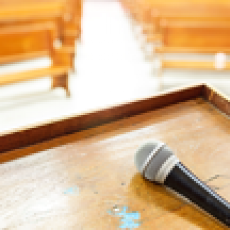 Semi-Annual / Annual Meeting with microphone on the lectern in the meeting facility.