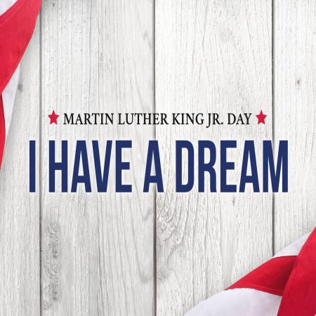 Martin Luther King Jr. 2022 I Have A Dream written words on white wood with a portion of the flag on the edge.